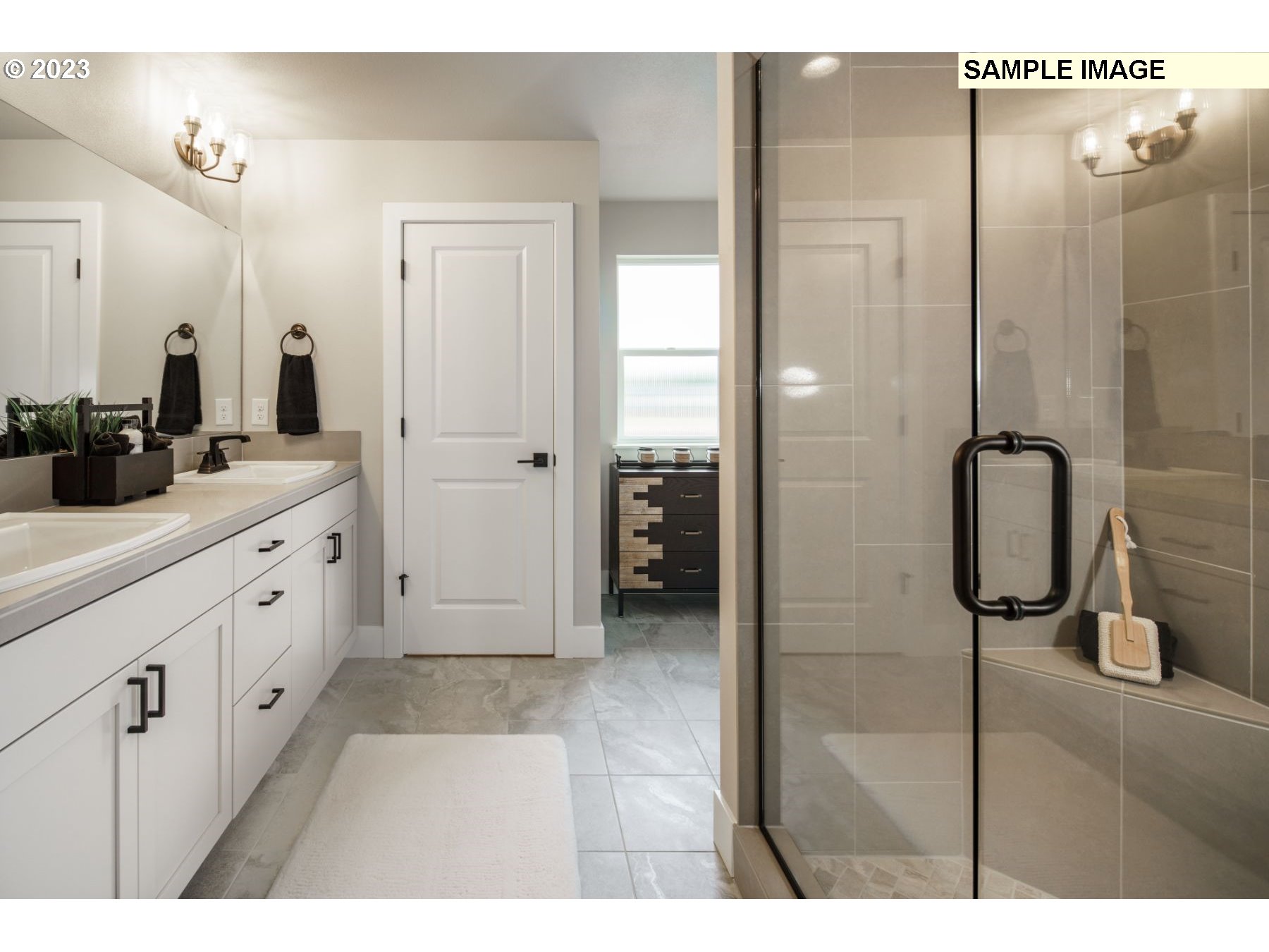 714 Northwest 178th Street Ridgefield, WA 98642 - Photo 17 of 31 a bathroom with a double vanity sink a large mirror and shower