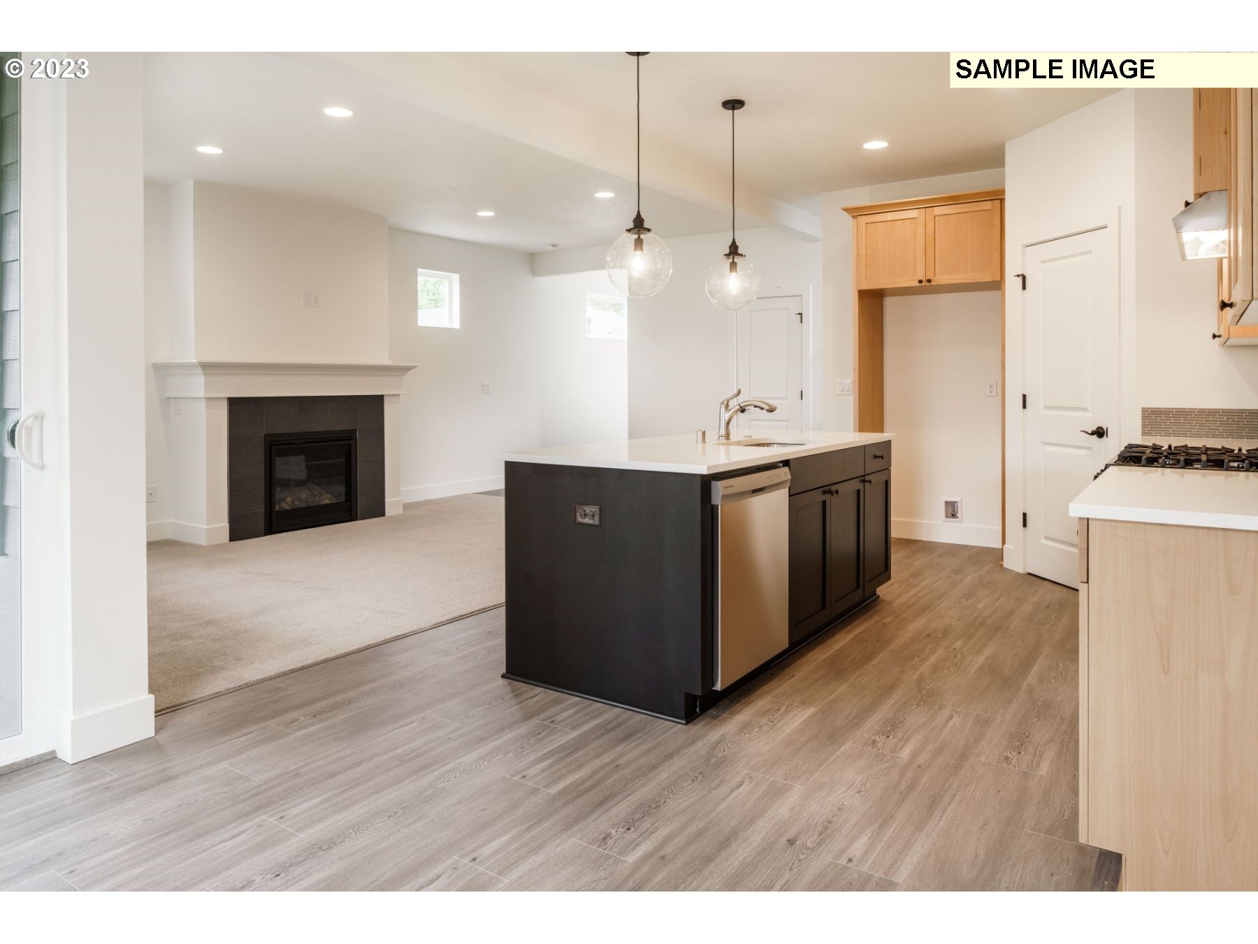 714 Northwest 178th Street Ridgefield, WA 98642 - Photo 26 of 31 a kitchen with stainless steel appliances granite countertop a stove top oven a refrigerator a sink and a fireplace with wooden floor