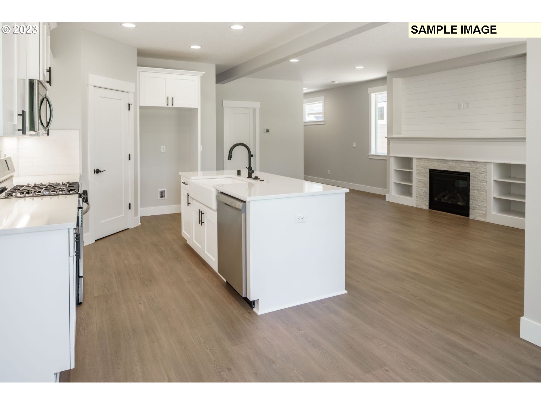 714 Northwest 178th Street Ridgefield, WA 98642 - Photo 29 of 31 a large white kitchen with a stove top oven