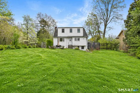 a view of house with backyard