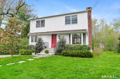 a front view of house with yard and green space