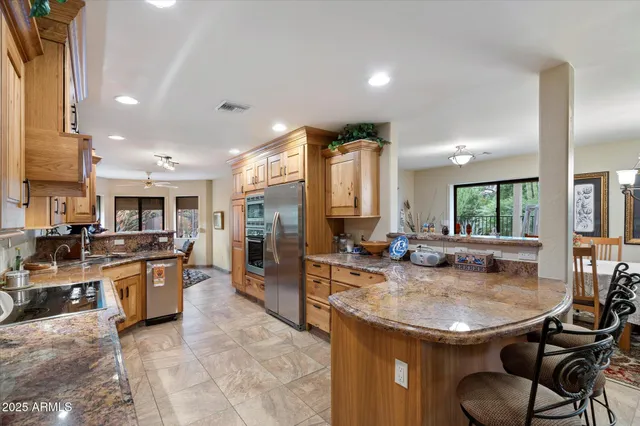 a kitchen with stainless steel appliances granite countertop a stove and refrigerator