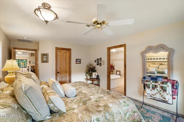 a bedroom with furniture and a chandelier