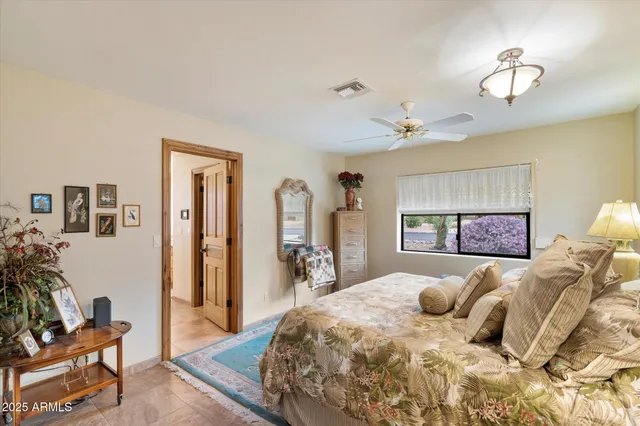 a bedroom with a large bed and a chandelier