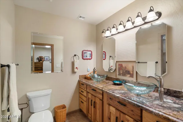 a bathroom with a granite countertop sink mirror and vanity
