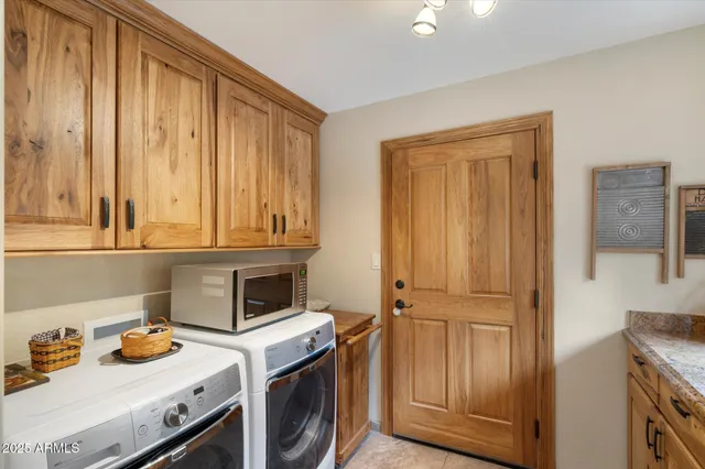 a view of storage and utility room with washer and dryer