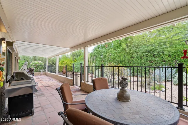 a view of a patio with a table chairs and a backyard
