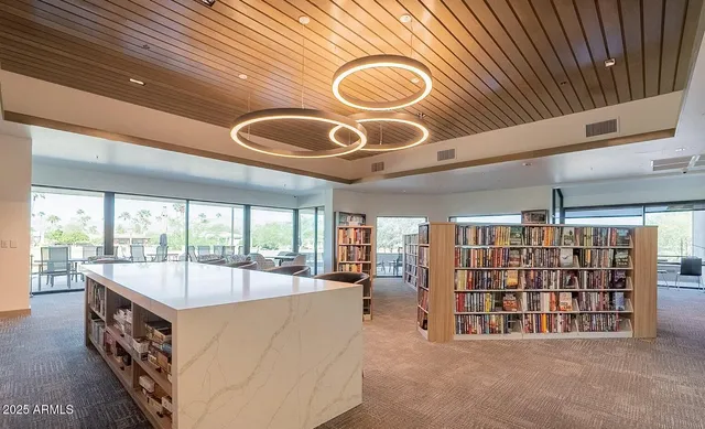 a dining hall with lots of chairs and chandelier