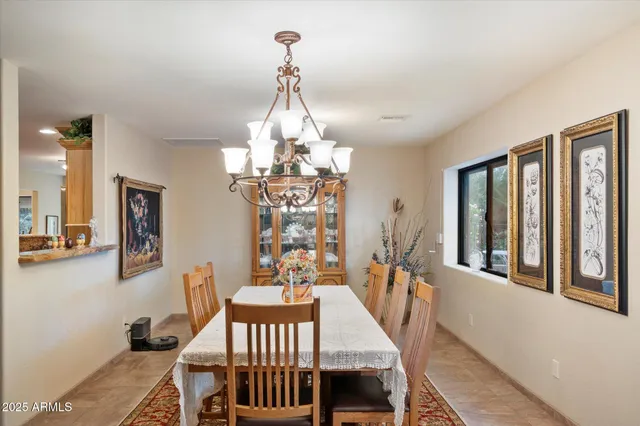 a view of a dining room with furniture and chandelier
