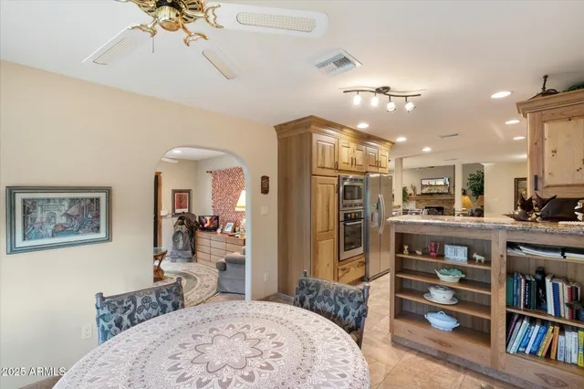a living room with furniture and a book shelf