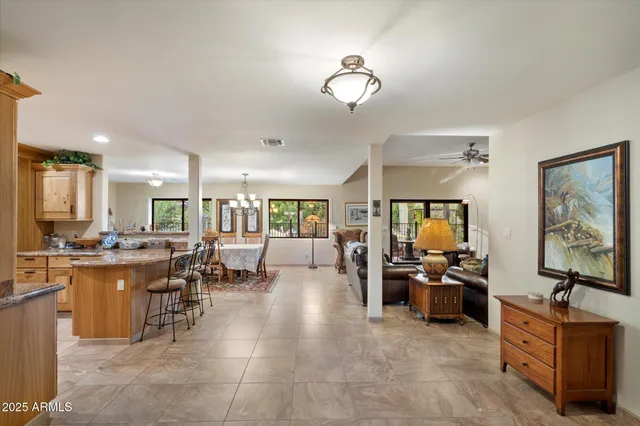 a living room with lots of furniture and kitchen view