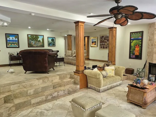 a living room with lots of furniture and a chandelier