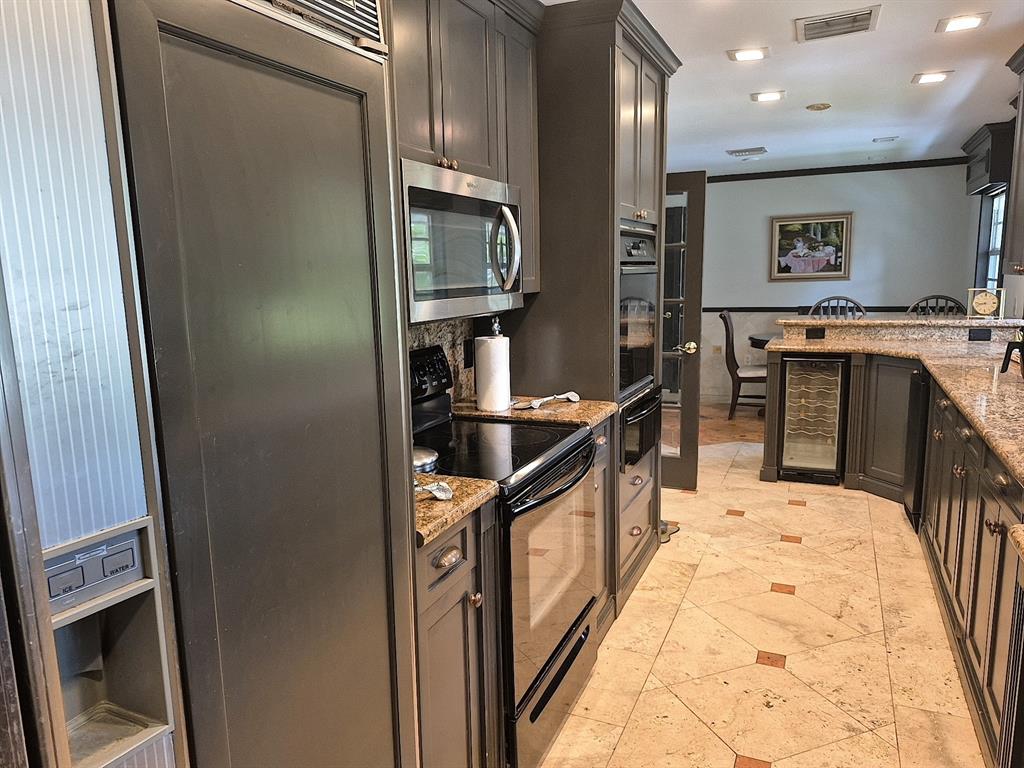 11081 Southwest 30th Court Davie, FL 33328 - Photo 18 of 29 a kitchen with granite countertop a stove and cabinets