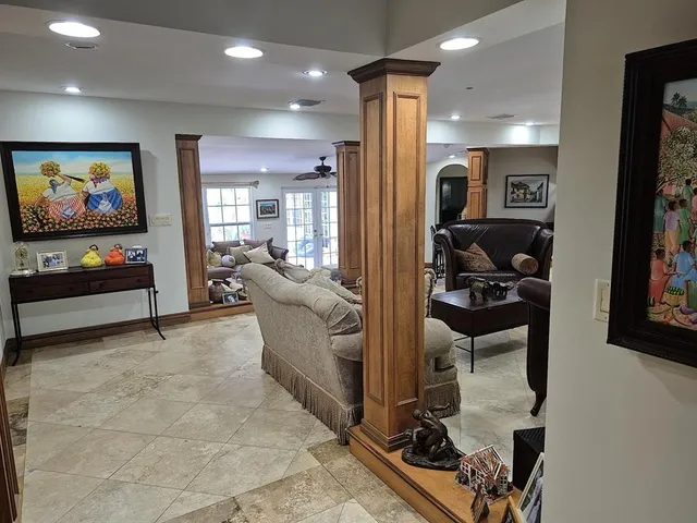a living room with furniture and a mirror