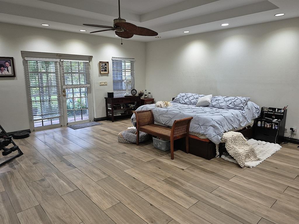 11081 Southwest 30th Court Davie, FL 33328 - Photo 21 of 29 a spacious bedroom with a bed and wooden floor