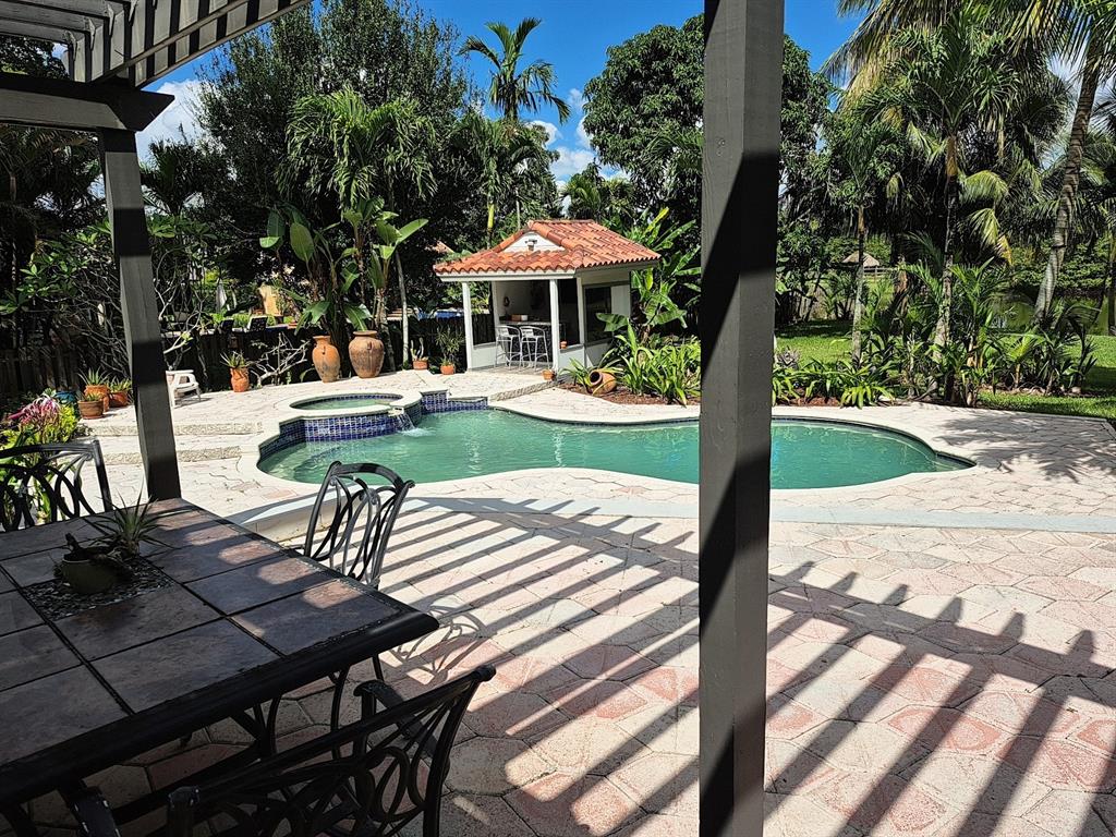 11081 Southwest 30th Court Davie, FL 33328 - Photo 4 of 29 a view of a patio with a table chairs and a table