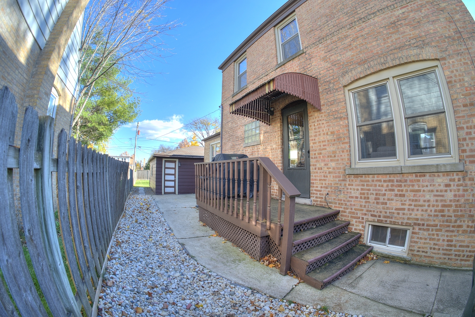 501 North Maple Street Mount Prospect, IL 60056 - Photo 27 of 27 a view of a brick house with a small yard and wooden floor and fence