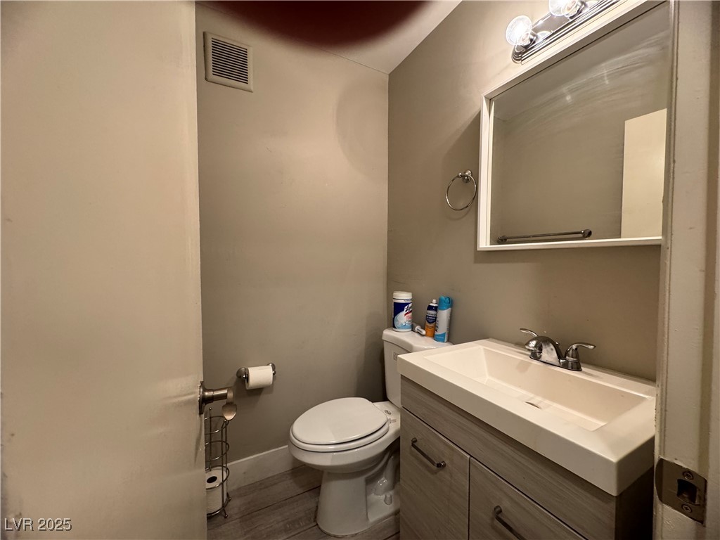 1409 Joshua Way Las Vegas, NV 89101 - Photo 7 of 15 Bathroom with vanity and wood finished floors