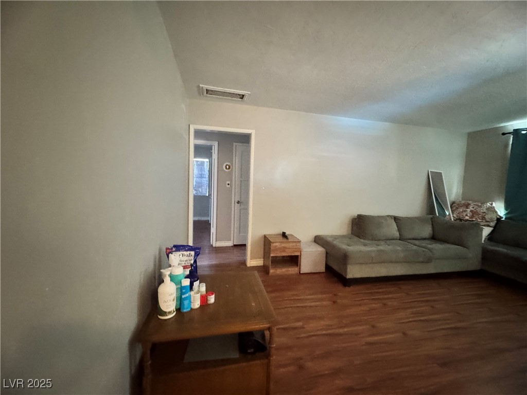 1409 Joshua Way Las Vegas, NV 89101 - Photo 9 of 15 Living room with dark wood finished floors and baseboards