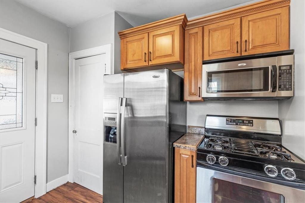 322 Ohio Avenue Rochester, PA 15074 - Photo 13 of 47 a kitchen with stainless steel appliances granite countertop a stove microwave and refrigerator