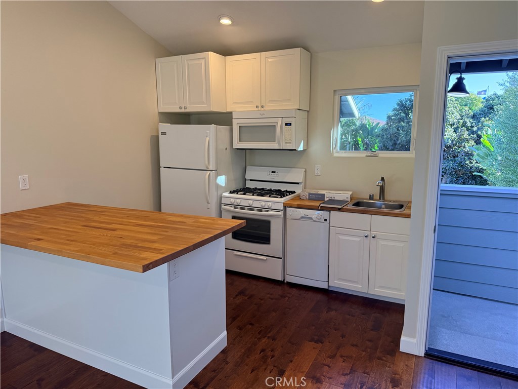 25422 Neptune Drive, Unit B Dana Point, CA 92629 - Photo 3 of 13 a kitchen with kitchen island granite countertop a stove a sink and a refrigerator