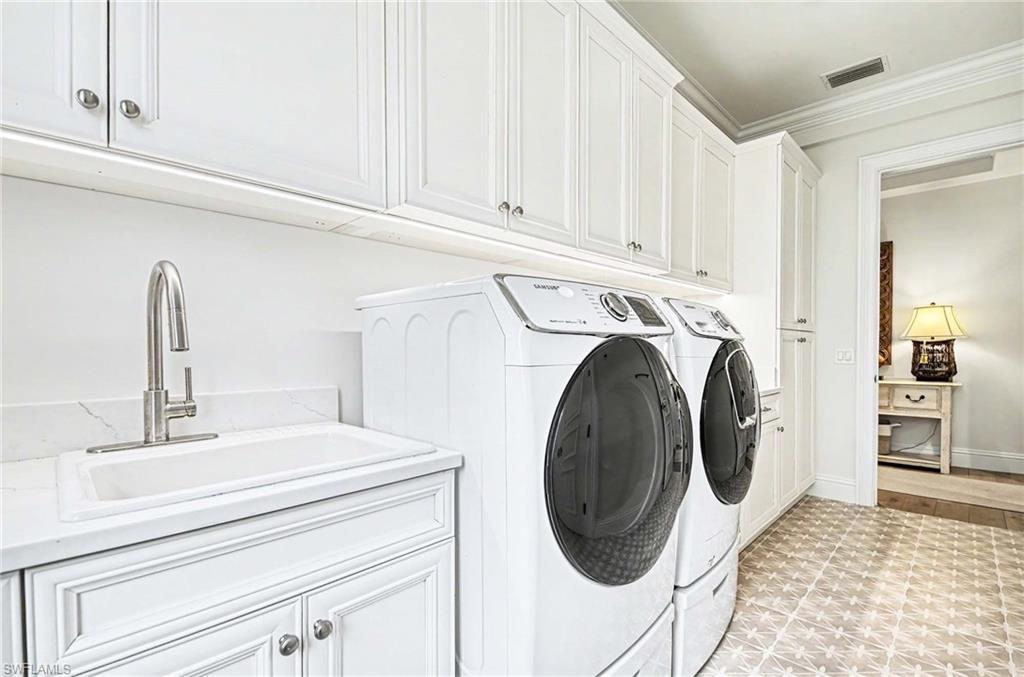 1888 6th Street South Naples, FL 34102 - Photo 35 of 37 a bathroom with a sink and a washer dryer