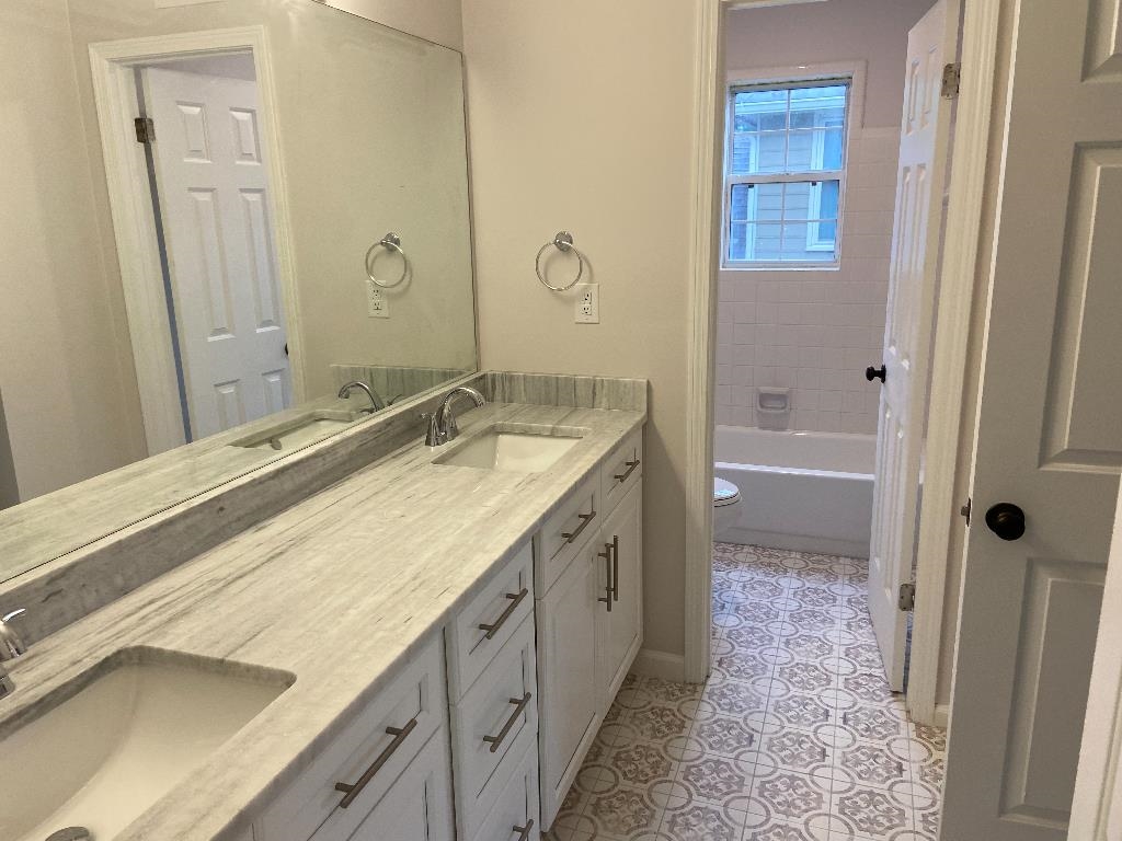 1212 Heather Ridge Cove Collierville, TN 38017 - Photo 13 of 25 a spacious bathroom with a granite countertop sink and a mirror