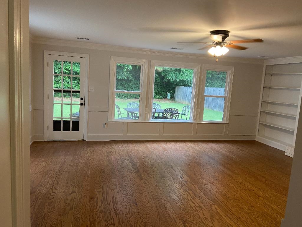 1212 Heather Ridge Cove Collierville, TN 38017 - Photo 4 of 25 a view of an empty room with wooden floor and a window