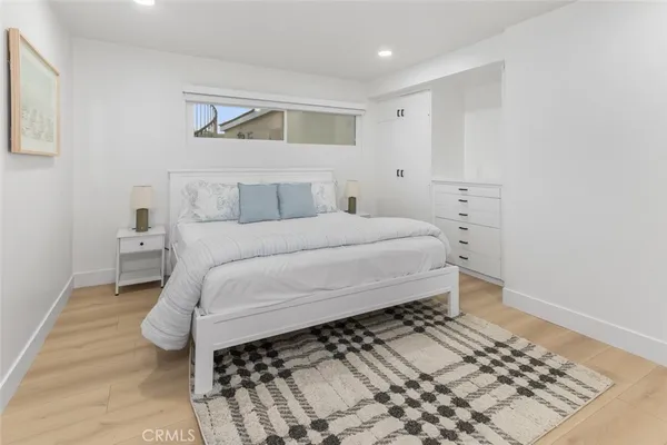 a bedroom with a bed and a lamp on desk