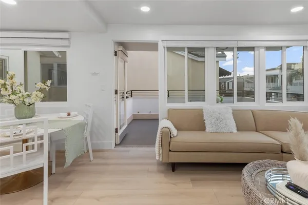a living room with furniture and a floor to ceiling window