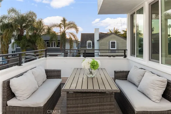 a view of a roof deck with couches and potted plants