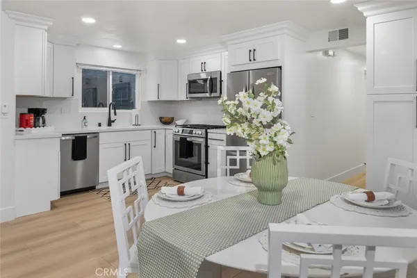 a kitchen with refrigerator and stove