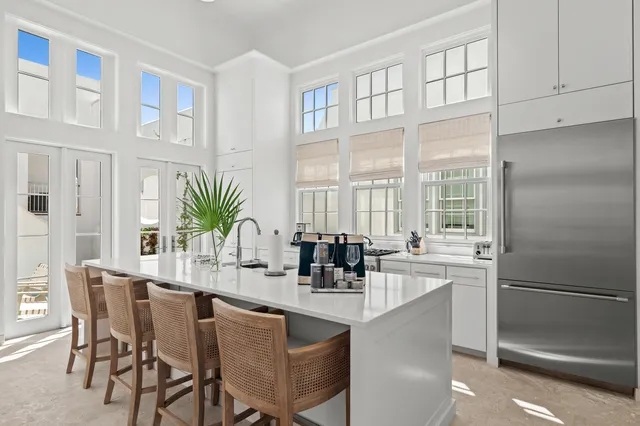 a dining room with stainless steel appliances granite countertop furniture and a refrigerator