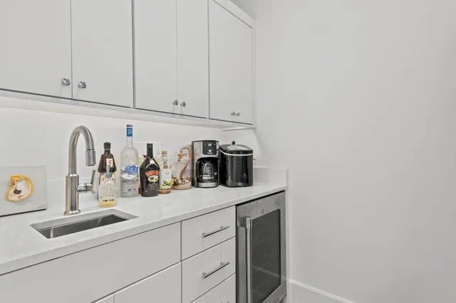 a kitchen with white cabinets and white appliances