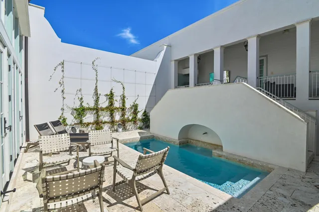 a front view of a house with outdoor space and seating area