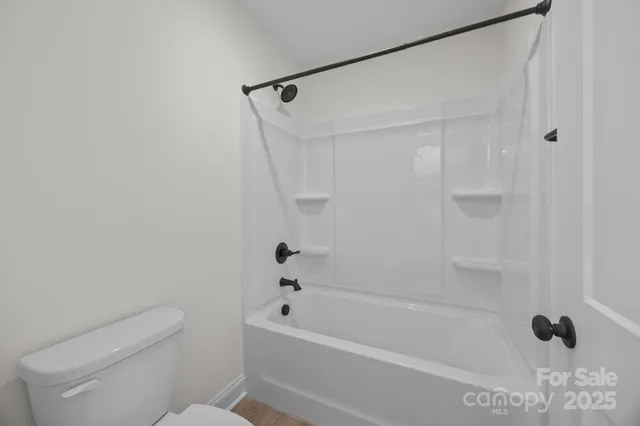 a bathroom with a shower and a toilet