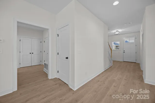 a view of a hallway with wooden floor