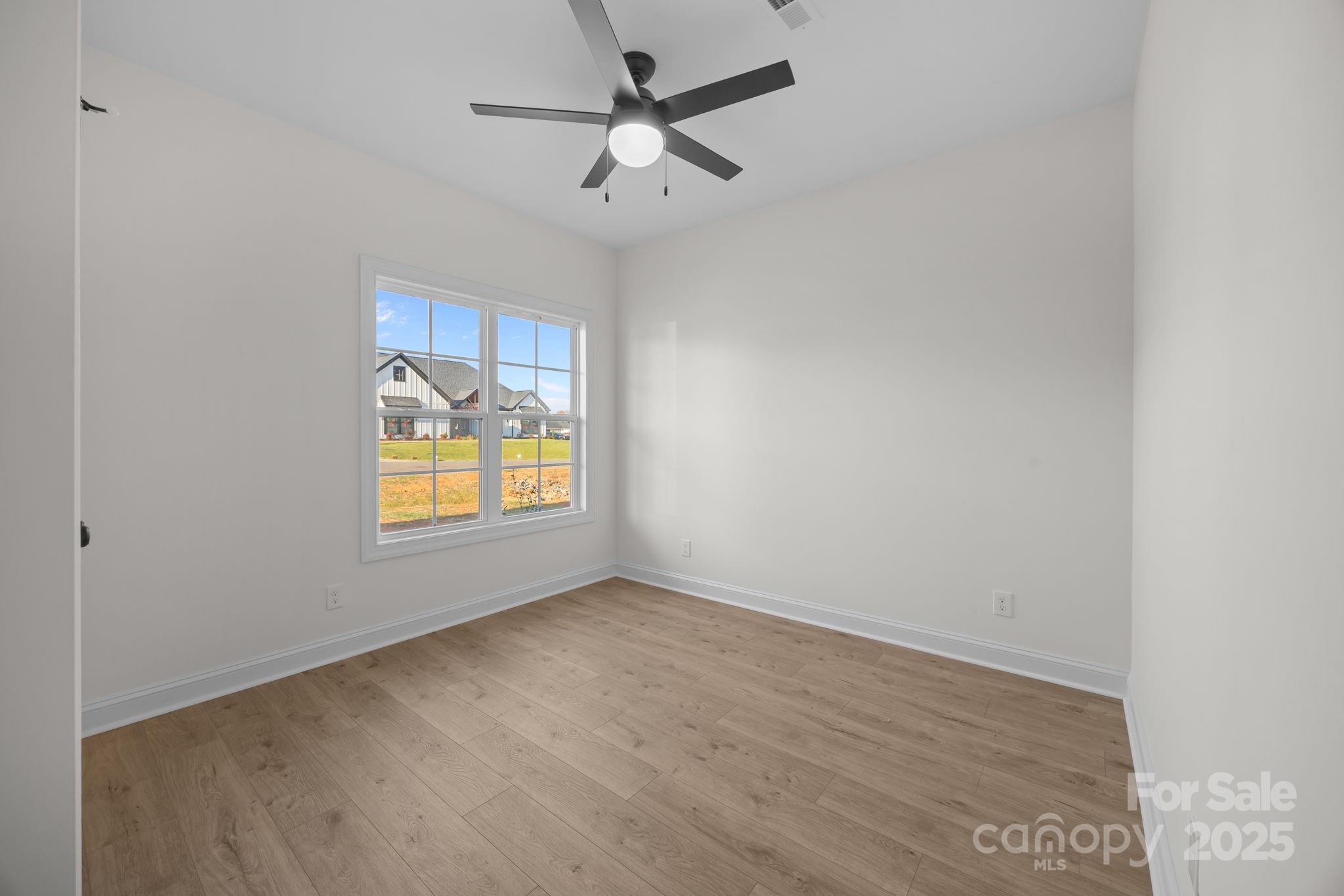 1325 Coppergate Drive Salisbury, NC 28147 - Photo 7 of 47 an empty room with a window and a fan