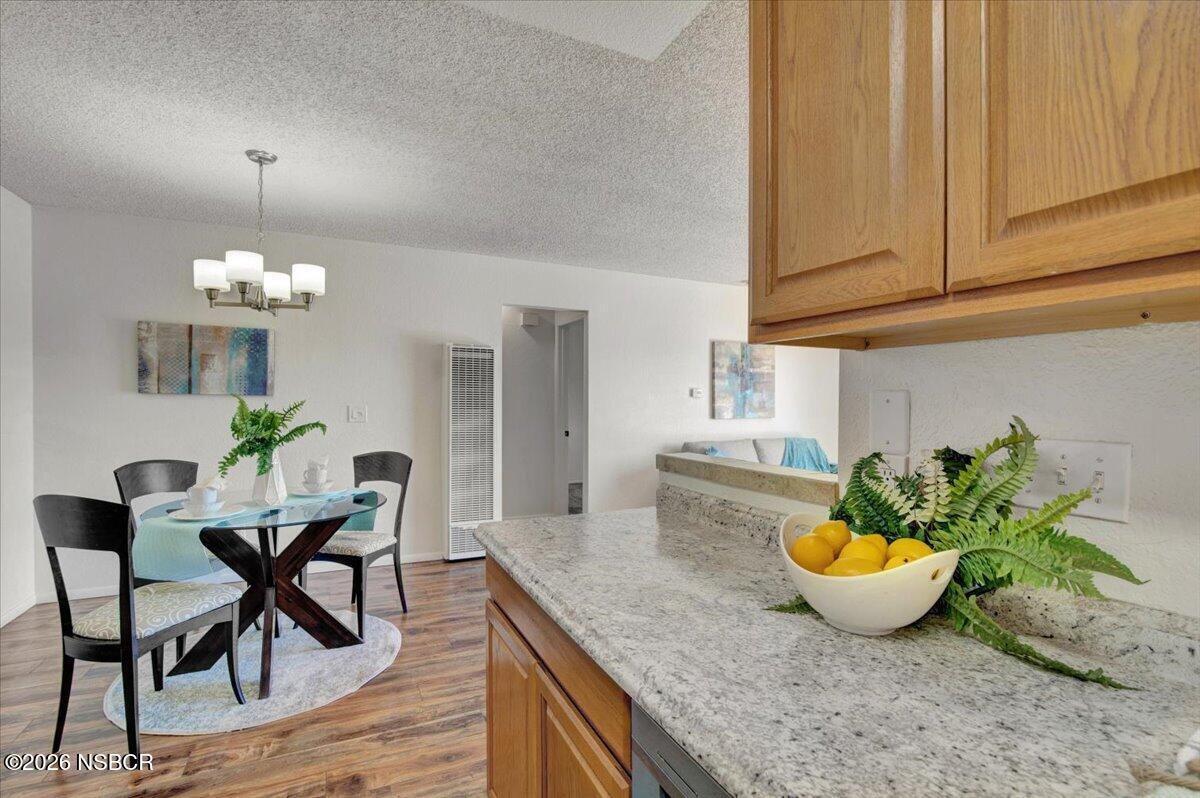 3400 Santa Maria Way, Unit 207B Santa Maria, CA 93455 - Photo 19 of 50 a view of a dining room with furniture and chandelier