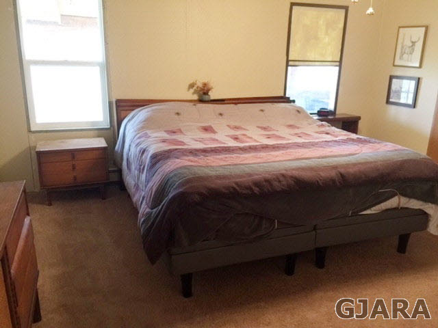 602 39 Road Palisade, CO 81526 - Photo 5 of 19 a bed sitting in a bedroom next to a window