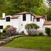 a front view of house with yard and green space