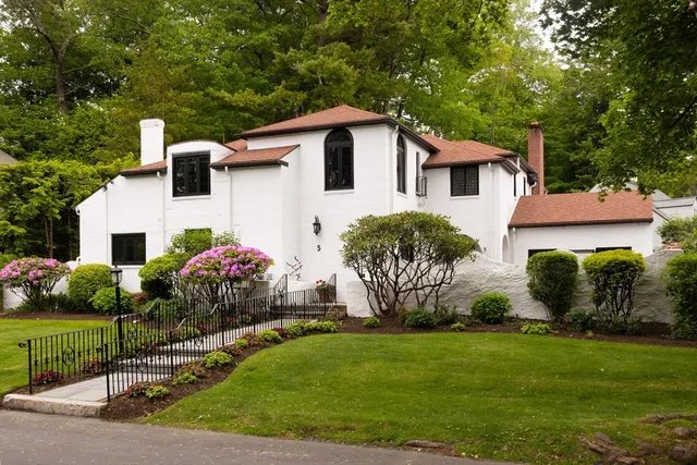 a front view of house with yard and green space