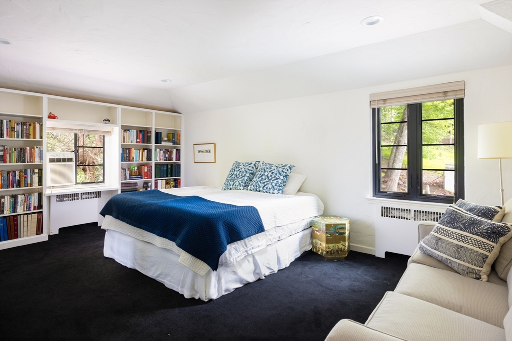 5 Southwick Road Newton, MA 02468 - Photo 15 of 25 a bedroom with a bed couch and a book shelf