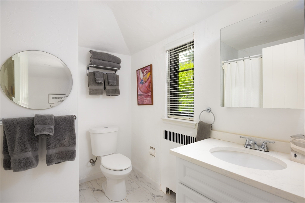 5 Southwick Road Newton, MA 02468 - Photo 16 of 25 a bathroom with a toilet a sink and mirror