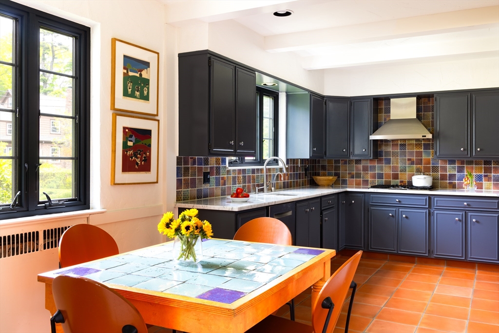 5 Southwick Road Newton, MA 02468 - Photo 10 of 25 a kitchen with stainless steel appliances granite countertop a stove a sink dishwasher a dining table and chair with wooden floor