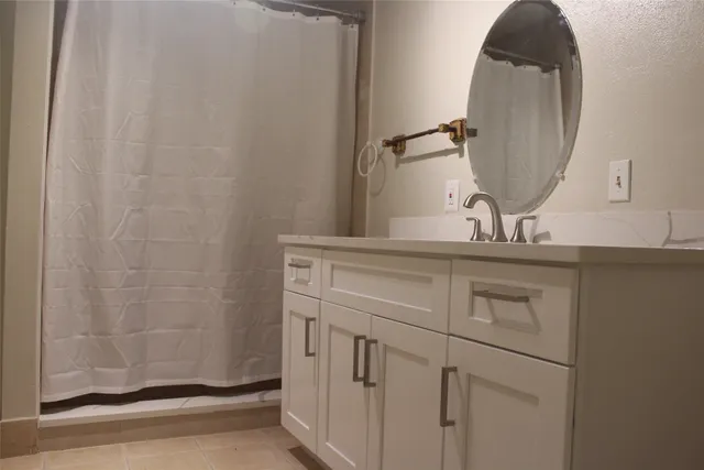 a white toilet sitting next to a shower