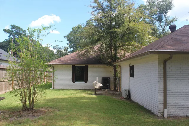 a backyard of a house with table and chairs