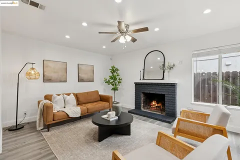 a living room with furniture and a fireplace