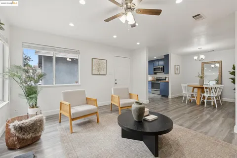 a living room with furniture and a dining table
