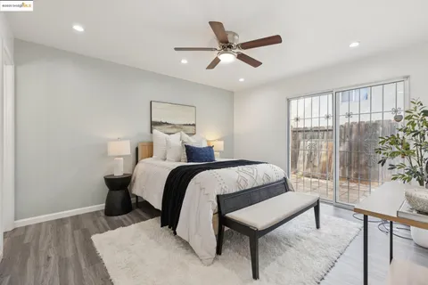 a bedroom with a bed and a potted plant